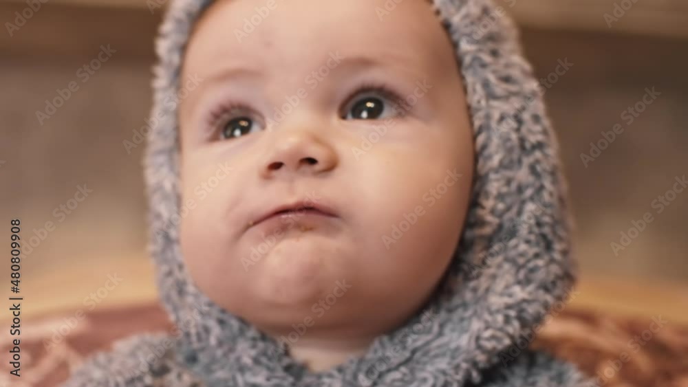 Close view of a baby boy eating in pyjama Close view of a baby boy eating in pyjama