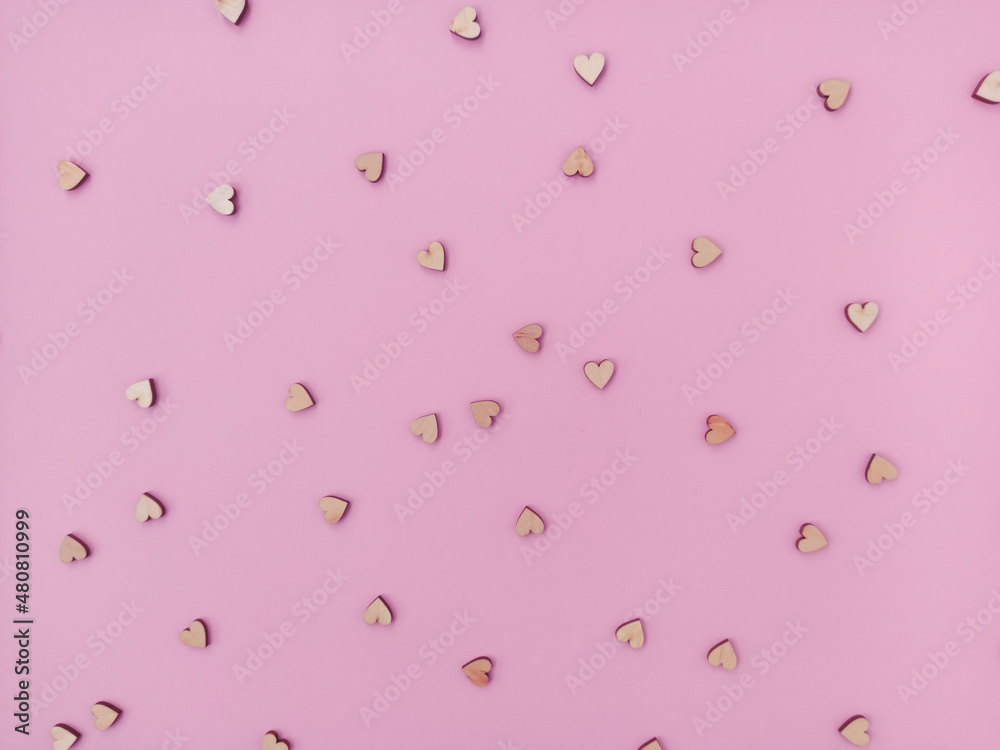 Lots of little wooden hearts on a pink background. Cute Valentine's Day card Lots of little wooden hearts on a pink background. Cute Valentine's Day card