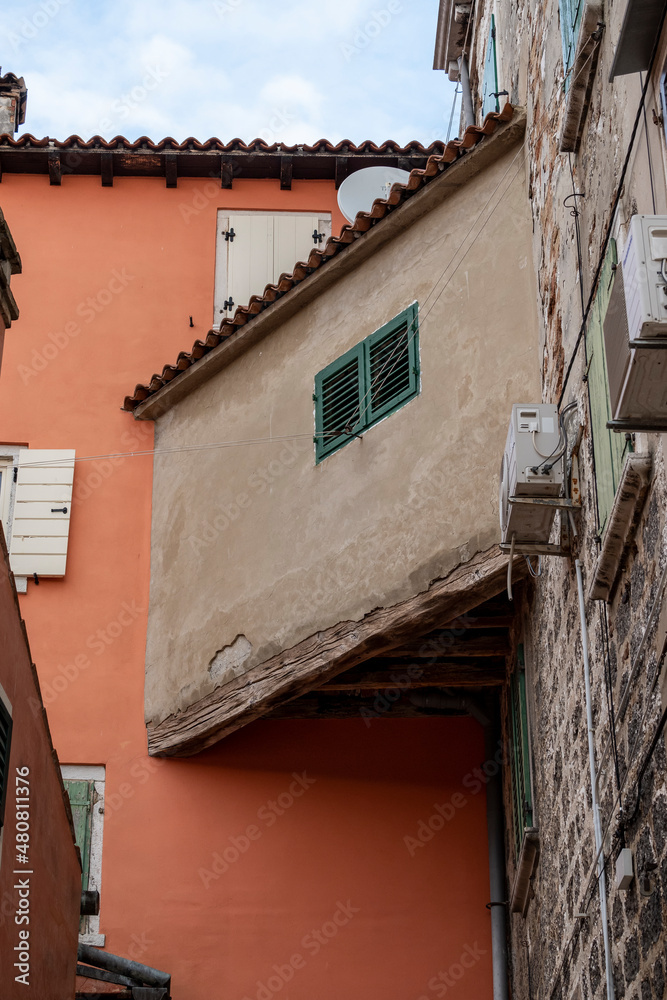 Beautiful old parts of ancient houses with colorful facades and window shutters in the Rovinj city streets, located on the istrian peninsula, Croatia