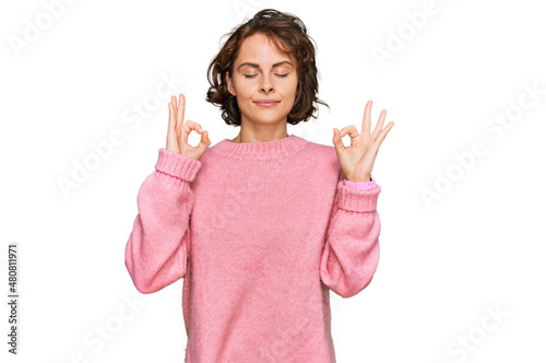 Young hispanic woman wearing casual clothes relaxed and smiling with eyes closed doing meditation gesture with fingers. yoga concept.