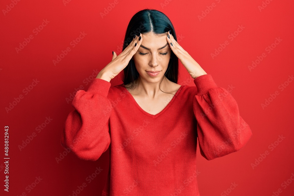 Young hispanic woman wearing casual clothes suffering from headache desperate and stressed because pain and migraine. hands on head. Young hispanic woman wearing casual clothes suffering from headache desperate and stressed because pain and migraine. hands on head.