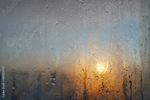 Fototapeta Naklejka Na Ścianę i Meble -  frost on the window at sunset