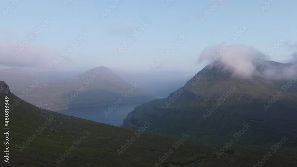 Mountains in Faroe Island with clouds during sunset Mountains in Faroe Island with clouds during sunset
