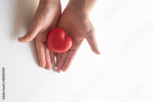 woman holding red heart in palm. concept of love, organ donation, health,awareness, wellbeing, family insurance.Healthy heart concept for healthy living.mental health.selective focus