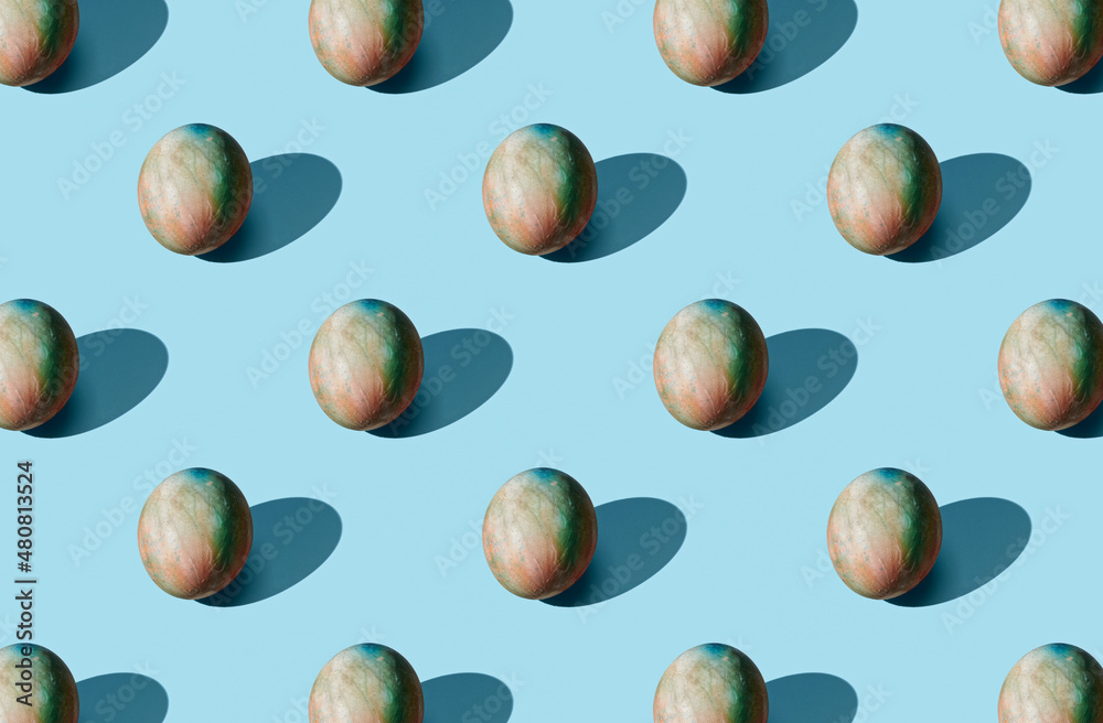 Pattern of easter eggs on green pastel background