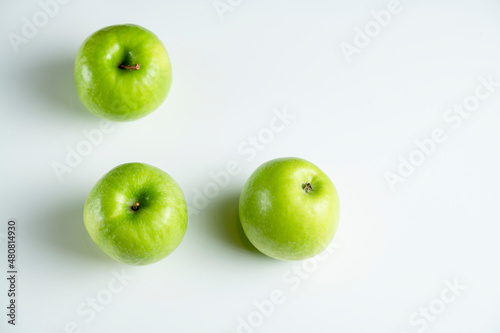 a whole green apple on a white background