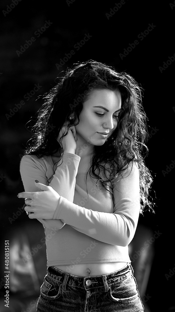 Portrait of a young girl in black clothes. Black background. Brown eyes. Portrait of a young girl in black clothes. Black background. Brown eyes.