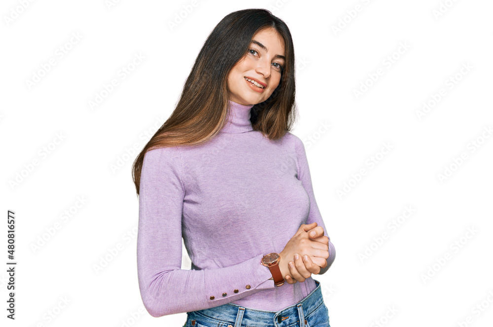 Young beautiful teen girl wearing turtleneck sweater with hands together and crossed fingers smiling relaxed and cheerful. success and optimistic Young beautiful teen girl wearing turtleneck sweater with hands together and crossed fingers smiling relaxed and cheerful. success and optimistic