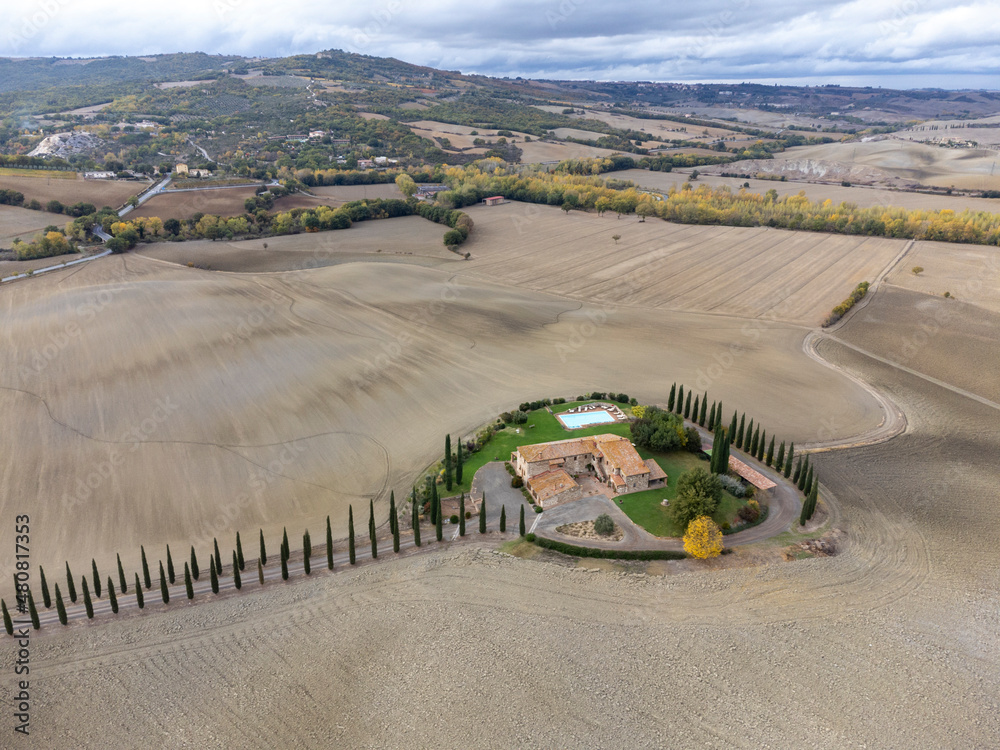 Fototapeta premium Aerial view on hills of Val d'Orcia, Tuscany, Italy. Tuscan landscape with ploughed fields in autumn.