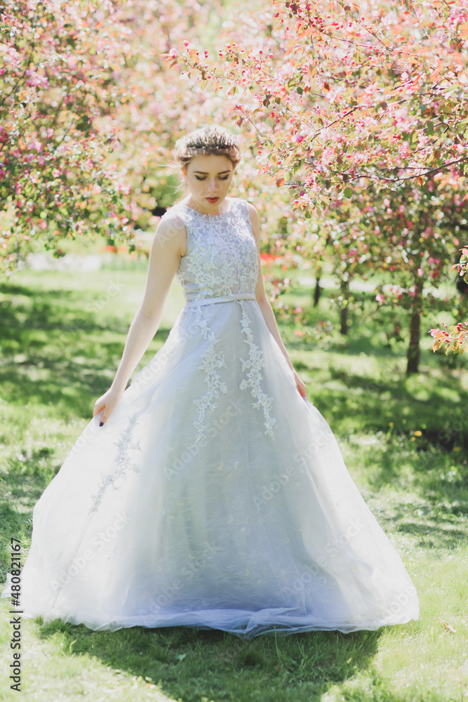 The beautiful woman in a dress with flowers.