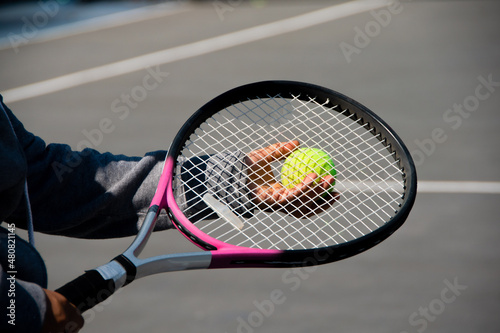 someone holding tennis ball and racket © Claudia Luna