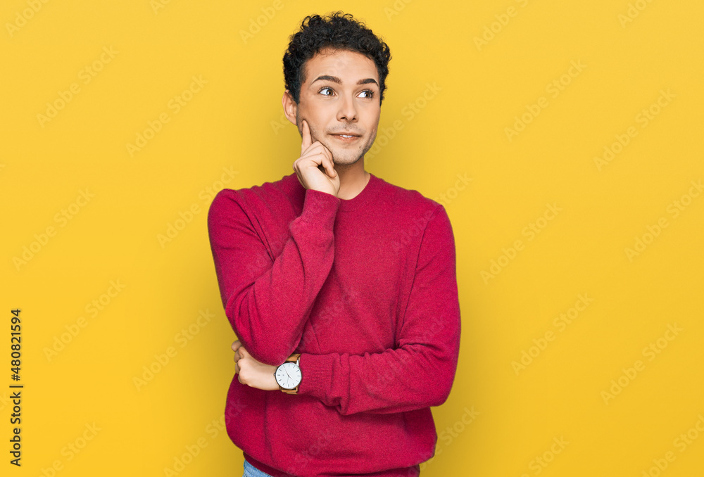 Obraz premium Young handsome man wearing casual clothes with hand on chin thinking about question, pensive expression. smiling and thoughtful face. doubt concept.
