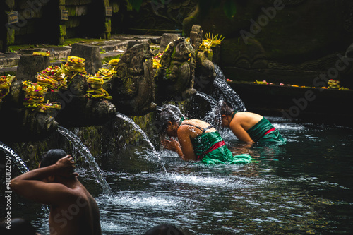 People bathing in Tirta Empul temple fountain 3