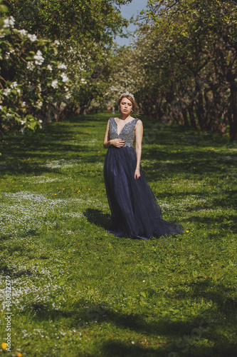 The sad woman in a dress in the forest.