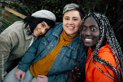 Portrait of multicultural girlfriends looking at the camera - only women concept photo