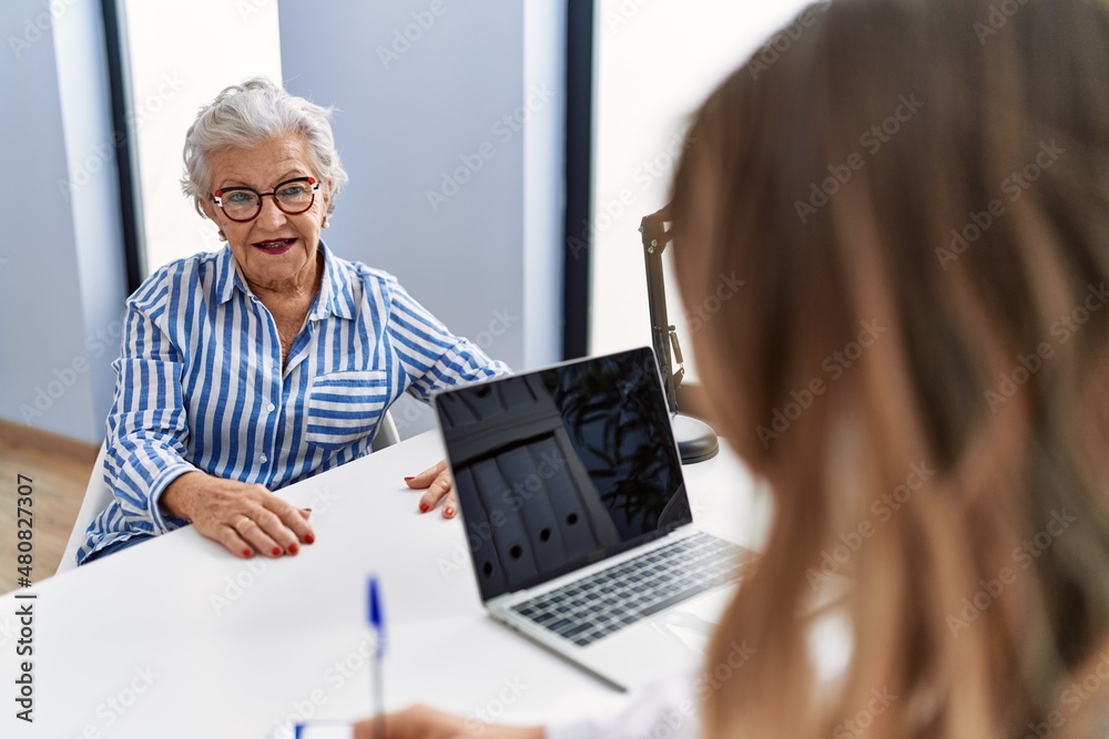 Senior grey-haired woman patient having medical consultation at clinic Senior grey-haired woman patient having medical consultation at clinic