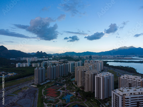 Aerial view of Ilha Pura Park at sunset. In the background, the hills of Rio de Janeiro, Brazil and the Jacarépagua lagoon. Sunny Day and some clouds. Drone take photo