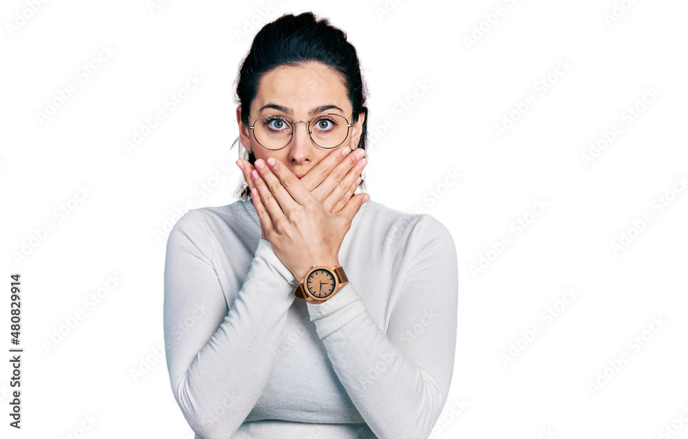 Young hispanic woman wearing casual clothes shocked covering mouth with hands for mistake. secret concept. Young hispanic woman wearing casual clothes shocked covering mouth with hands for mistake. secret concept.