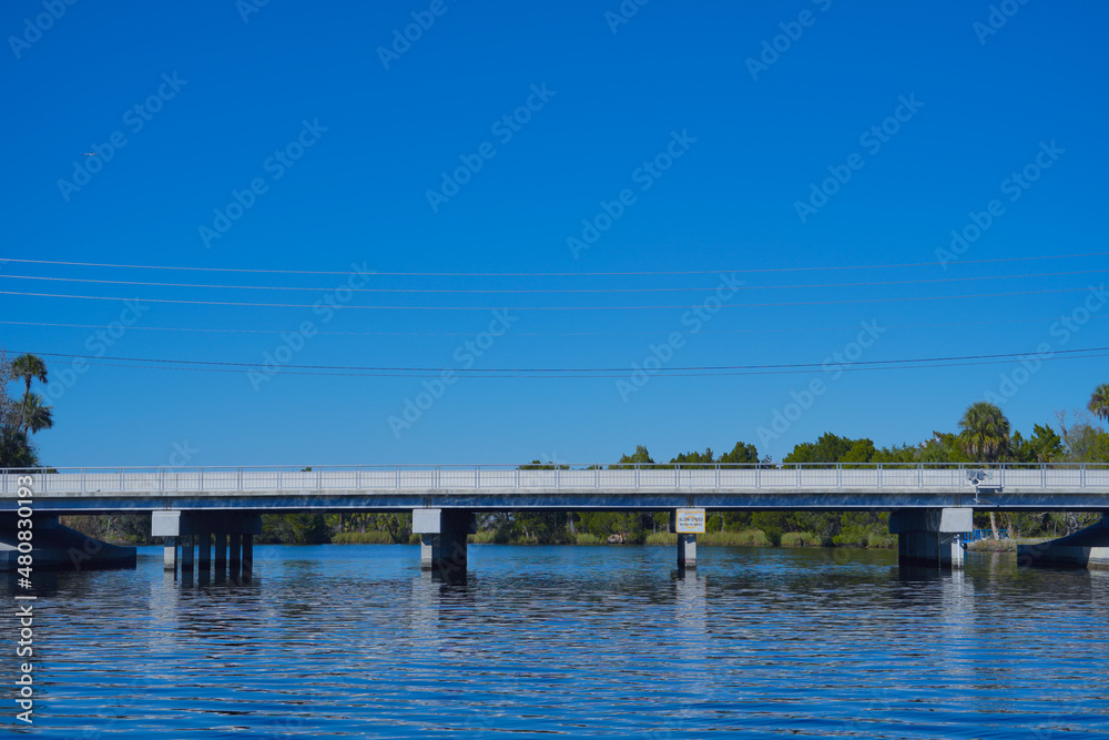 beautiful tree, clear water, and house along homossasa river in winter. beautiful tree, clear water, and house along homossasa river in winter.