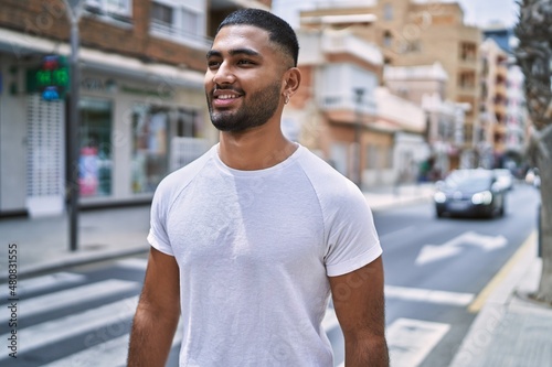 Young middle east man smiling happy standing at the city.