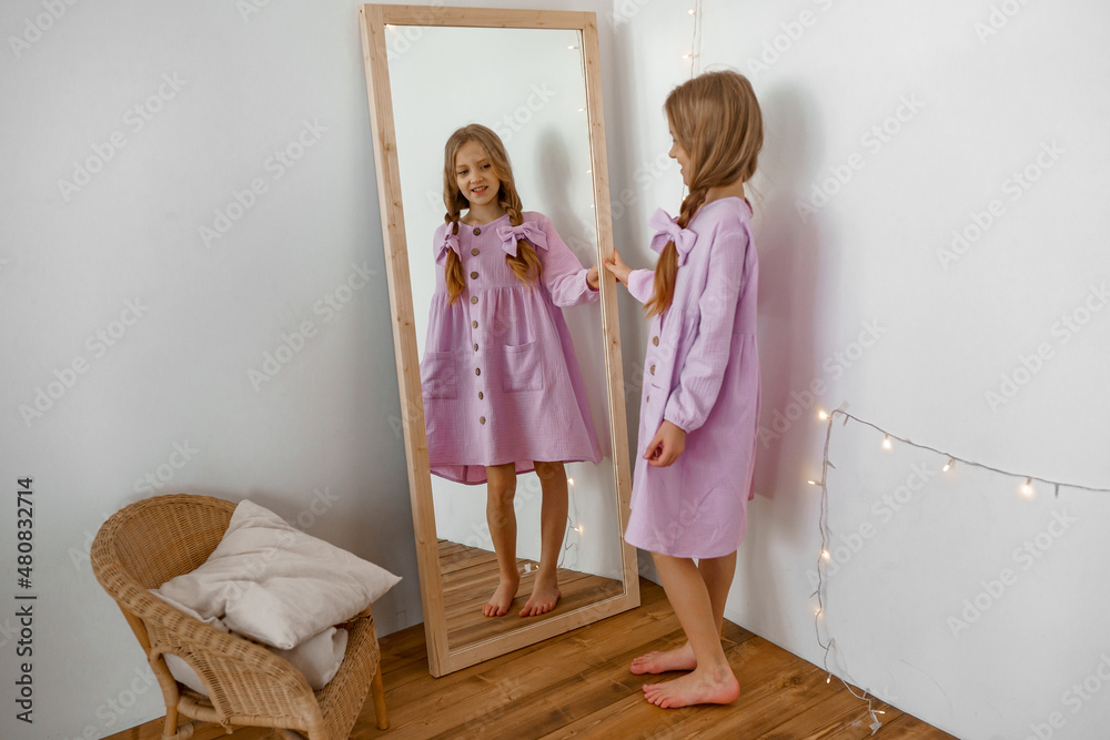 a girl in a purple dress, at the mirror.color of the year. a girl in a purple dress, at the mirror.color of the year.