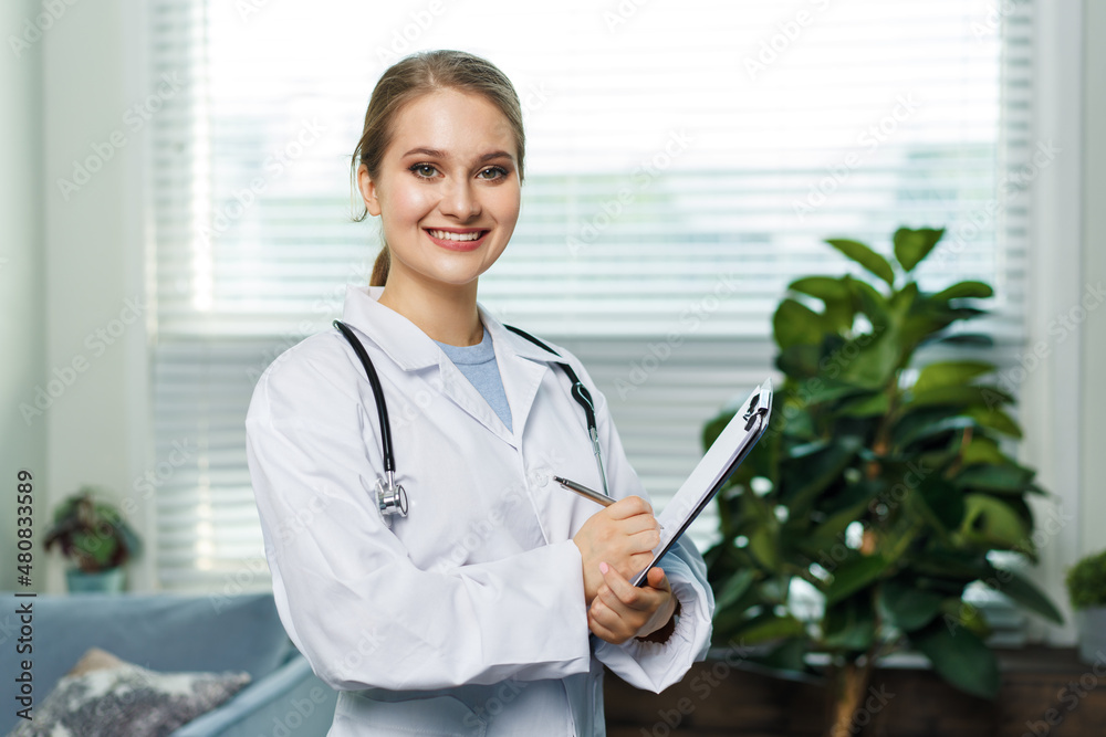 Portrait of a woman doctor with stetoscope looking at camera. Smiling female doctor in a clinic background. Portrait of a woman doctor with stetoscope looking at camera. Smiling female doctor in a clinic background.