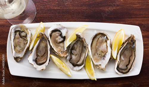 Oysters with lemon on plate. High quality photo photo
