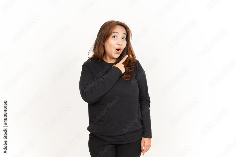 Pointing product on the side Of Beautiful Asian Woman Wearing Black Shirt Isolated On White Pointing product on the side Of Beautiful Asian Woman Wearing Black Shirt Isolated On White