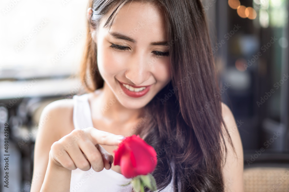 Beautiful Asian girl holding red rose with happiness smile in her wonderful Valentine's Day Beautiful Asian girl holding red rose with happiness smile in her wonderful Valentine's Day
