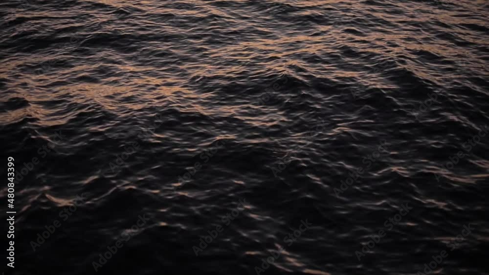 Dusk light reflecting on the water surface of the sea lake. Peaceful waves water ripples Dusk light reflecting on the water surface of the sea lake. Peaceful waves water ripples