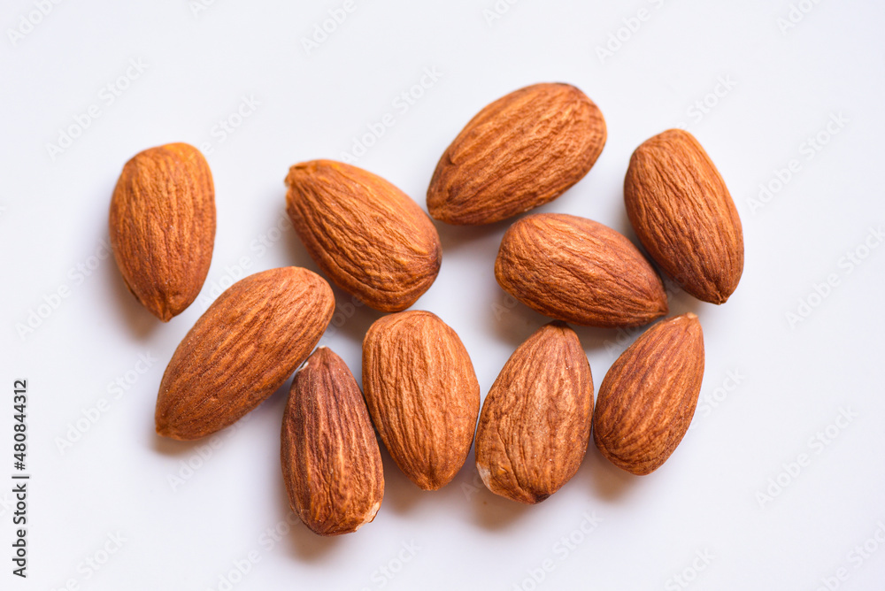 Almonds on white background top view on the table, Close up roasted almond nuts natural protein food and for snack Almonds on white background top view on the table, Close up roasted almond nuts natural protein food and for snack