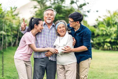 Portrait enjoy happy smiling love multi-generation asian big hug family.Senior mature father and elderly mother with young adult woman and son outdoor in park at home.insurance concept © Art_Photo