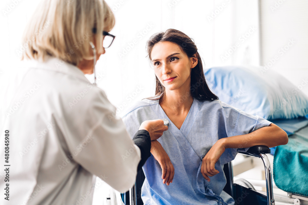 Fototapeta premium Senior woman doctor wearing uniform with stethoscope service help support discussing and consulting talk to sick woman patient about checkup result information in hospital