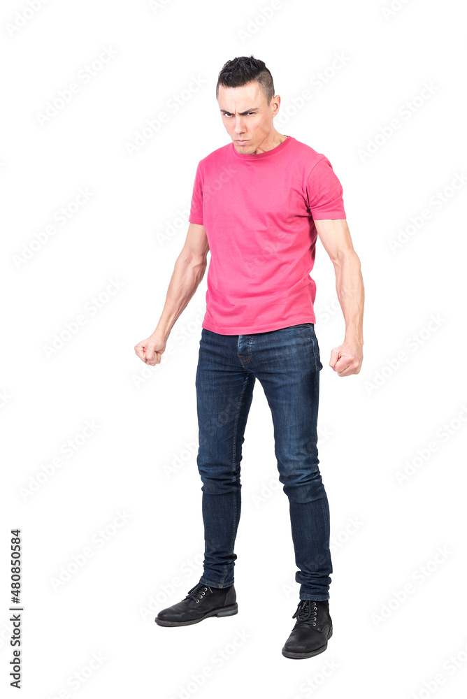 Nervous young man clenching fists in white studio Nervous young man clenching fists in white studio