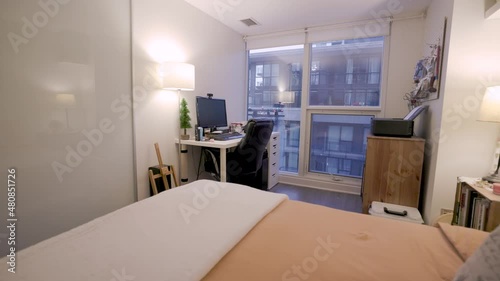 Bedroom Fly-through Warm Inviting Condominium Interior with Work From Home Office Printer and Computer Desk photo