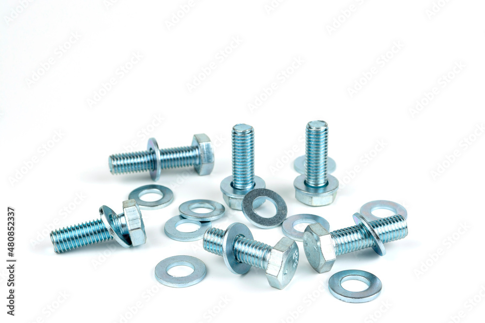 several metal bolts with washers and nuts on a white background. close-up several metal bolts with washers and nuts on a white background. close-up