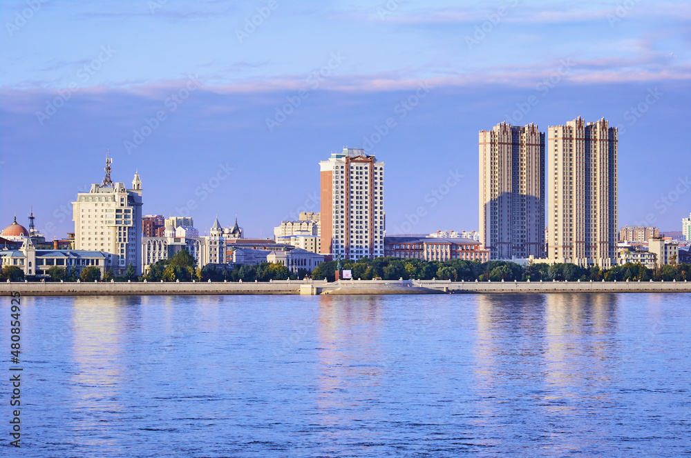 Russian-Chinese border along the Amur River. View from the embankment of the city of Blagoveshchensk, Russia to the city of Heihe, China. A mixture of architectural styles. Russian-Chinese border along the Amur River. View from the embankment of the city of Blagoveshchensk, Russia to the city of Heihe, China. A mixture of architectural styles.