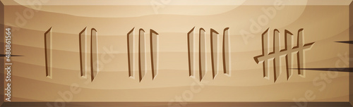 Wood board with several Tally scratch marks carved over wooden background.