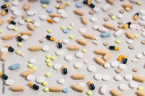 Pharmaceutical pattern of many multicolored drugs and pills. Composition on a light background. Healthy care concept.