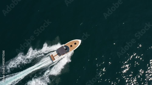 Wallpaper Mural Modern boat fast movement diagonally top view. A large white boat with an awning moves on turquoise water aerial view. Torontodigital.ca