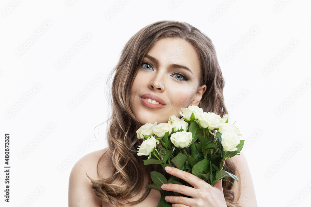 Beautiful young woman with flowers. Young smiling blonde with a delicate bouquet of white roses. Cosmetology and spa, spring and Valentine's Day. White background. Close-up. Beautiful young woman with flowers. Young smiling blonde with a delicate bouquet of white roses. Cosmetology and spa, spring and Valentine's Day. White background. Close-up.
