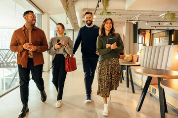 Multiethnic businesspeople walking through a modern office