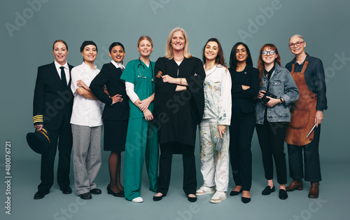 Cheerful female professionals smiling happily in a studio photo
