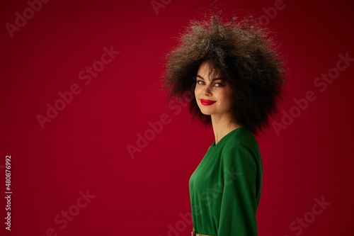 pretty woman in green dress afro hairstyle studio