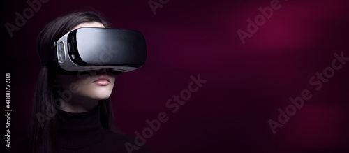 Young woman wearing a VR headset and experiencing virtual reality