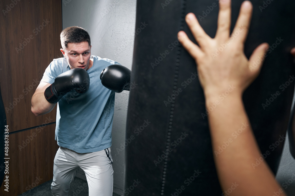 Focused sportsman getting ready for boxing workout Focused sportsman getting ready for boxing workout