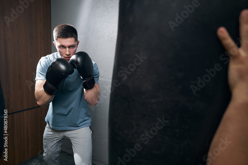 Serious focused Caucasian kickboxer preparing for workout © Viacheslav Yakobchuk