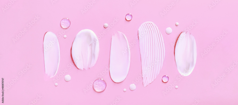 banner cosmetic smears cream texture on pastel pink background