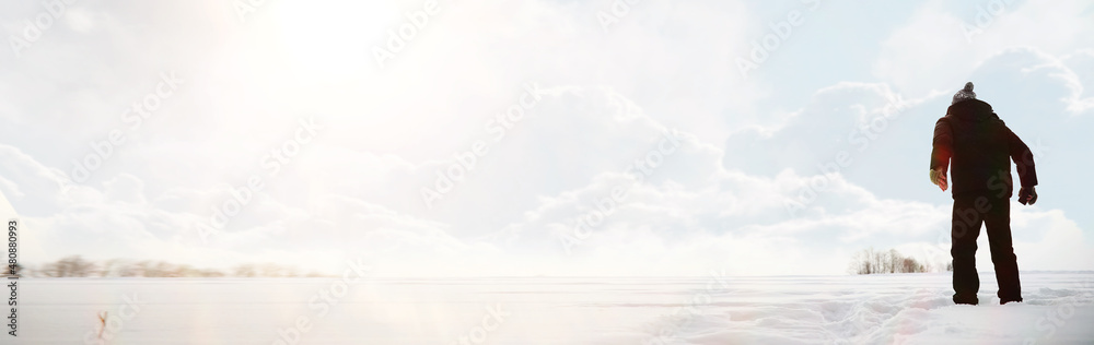 Fototapeta premium A man on a walk. Winter landscape. Tourist in winter journey.