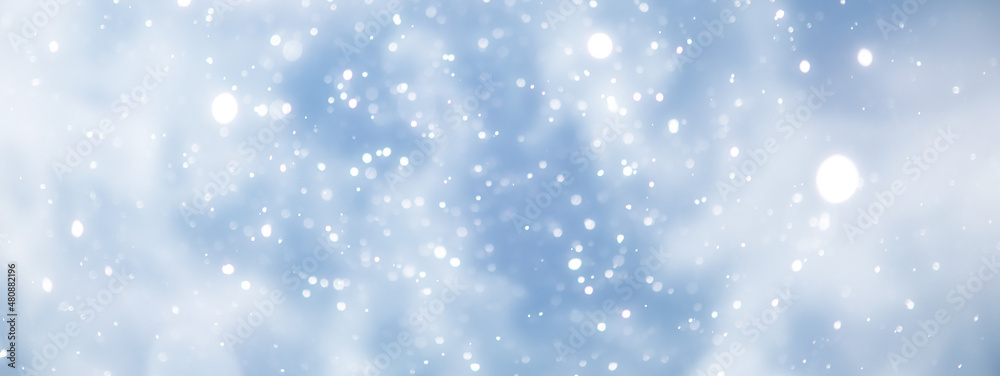 Fototapeta premium blue snowfall bokeh background, abstract snowflake background on blurred abstract blue